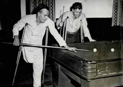 Press photograph of two men playing billiard