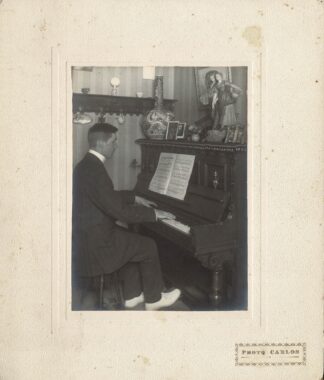 A man playing the piano. - 1916