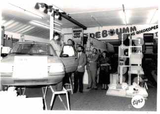 Five photographs of a Peugeot car being given away at a carpet store. - undated.