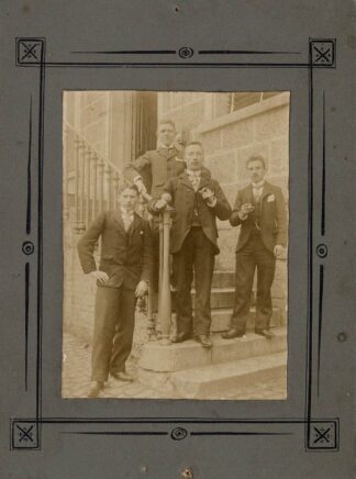 Four guys posing a staircase.