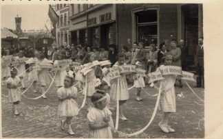Girls holding signs while walking in a procession - undated