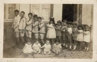 Kids in a line holding each other - undated