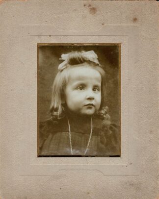 Photograph of a cute cross-eyed girl. - undated