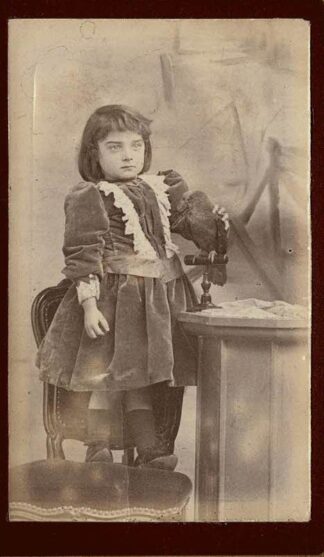 Photograph of a girl posing with a bird.