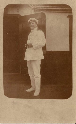 Sailor smiling while smoking a cigarette on the deck - undated