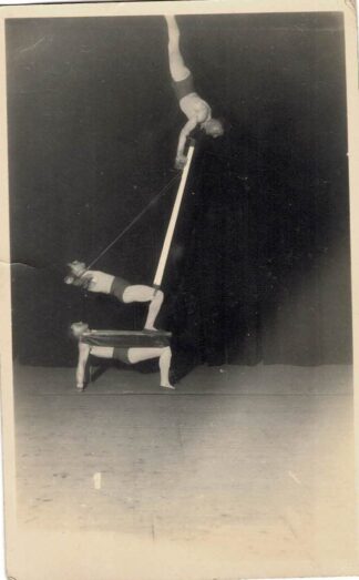 Three men performing a stunt.